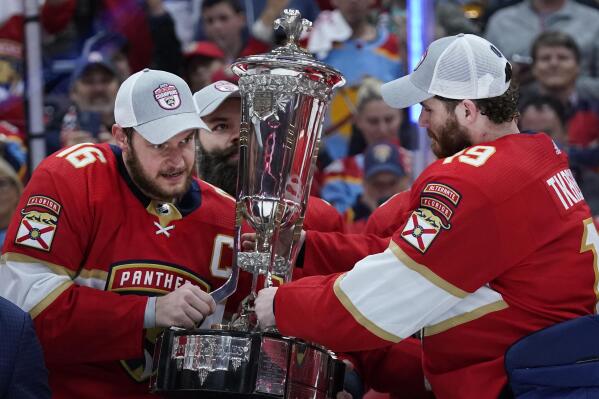 Florida Panthers center Aleksander Barkov, left and left wing Matthew Tkachuk, right, hold up the Prince of Wales trophy after the Panthers won Game 4 of the NHL hockey Stanley Cup Eastern Conference finals against the Carolina Hurricanes, Wednesday, May 24, 2023, in Sunrise, Fla. (AP Photo/Wilfredo Lee)