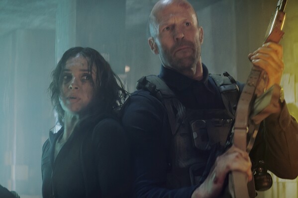 This image released by Amazon MGM Studios shows Arianna Rivas , left, and Jason Statham in a scene from "A Working Man." (Amazon MGM Studios via AP)