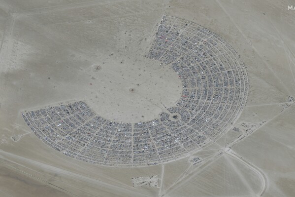 In this satellite photo provided by Maxar Technologies, an overview of Burning Man festival in Black Rock, Nev on Monday, Aug. 28, 2023. (©2023 Maxar Technologies via AP)