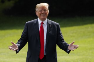 President Donald Trump gestures as reporters shout questions on his way to board Marine One on the South Lawn of the White House, Tuesday, May 29, 2018, in Washington. (AP Photo/Evan Vucci)