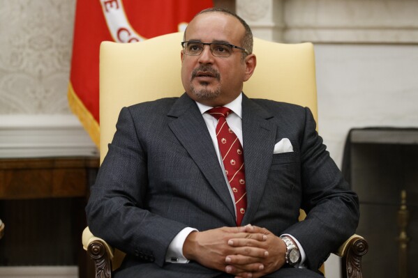 FILE - Bahrain's Crown Prince Salman bin Hamad Al Khalifa during a meeting in the Oval Office of the White House, on Sept. 16, 2019, in Washington. Hundreds of prisoners have suspended their monthlong hunger strike in Bahrain just ahead of a visit of the island nation’s crown prince to the United States. The strike will pause until Sept. 30 as some prisoners suffered health problems and to see if promised changes by Bahrain’s government at the Jaw Rehabilitation and Reform Center will happen. (AP Photo/Alex Brandon)