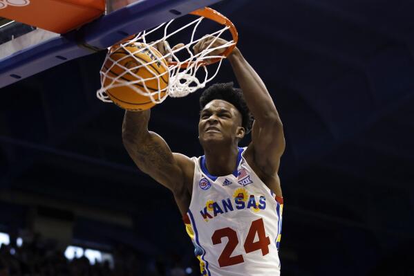 Kansas forward K.J. Adams Jr. dunks against Baylor during the first half of an NCAA college basketball game, Saturday, Feb. 18, 2023, in Lawrence, Kan. (AP Photo/Colin E. Braley)