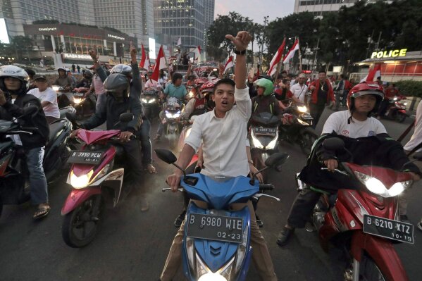 
              Supporters of Indonesian President Joko Widodo celebrate during a rally in Jakarta, Indonesia, Wednesday, April 17, 2019. Widodo is on track to win a second term, preliminary election results showed Wednesday, in apparent victory for moderation over the ultra-nationalistic rhetoric of his rival Prabowo Subianto. (AP Photo/Dita Alangkara)
            