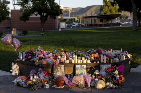 Pictures, flowers and candles mark a makeshift memorial Tuesday, June 3, 2025, in Wenatchee, Wash., in honor of Olivia, Paityn and Evelyn Decker, who were found dead near Leavenworth after their father Travis Decker failed to return them after a scheduled visitation. (Nick Wagner/The Seattle Times via AP)