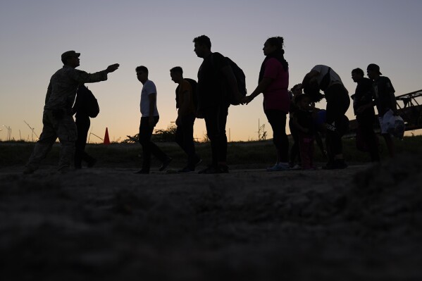 FILE - Migrants who crossed the Rio Grande and entered the U.S. from Mexico are lined up for processing by U.S. Customs and Border Protection, Saturday, Sept. 23, 2023, in Eagle Pass, Texas. (AP Photo/Eric Gay, File)