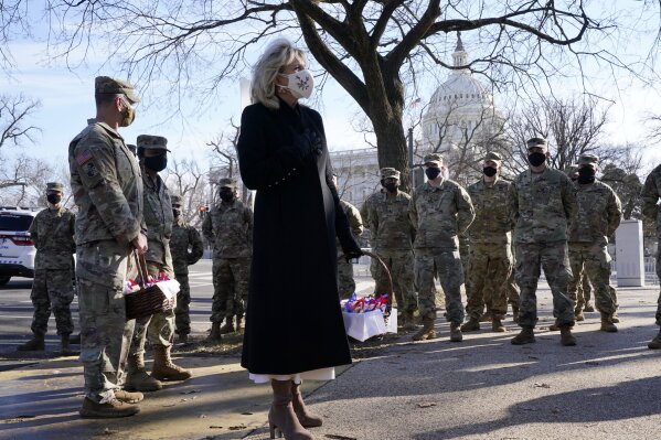 First lady Jill Biden surprises National Guard members outside the Capitol with chocolate chip cookies, Friday, Jan. 22, 2021, in Washington. (AP Photo/Jacquelyn Martin, Pool)