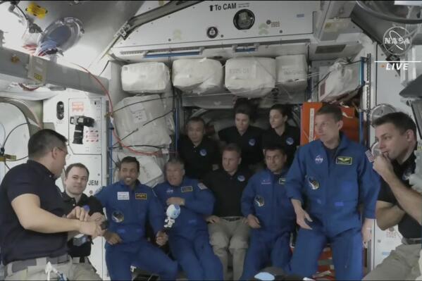 In this image from NASA TV, the four astronauts including United Arab Emirates' Sultan al-Neyadi, third left gather, during the welcoming ceremony, on the International Space Station, Friday, March 3, 2023. A new crew from the United States, Russia and United Arab Emirates has arrived at the International Space Station. The new arrivals include United Arab Emirates' Sultan al-Neyadi, the first astronaut from the Arab world who will spend an extended time in space. Al-Neyadi is only the second person from the UAE to rocket into orbit. (NASA TV via AP)