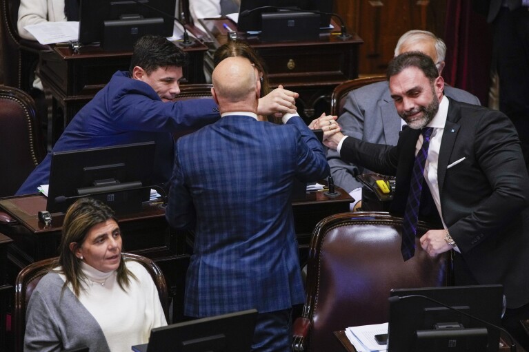 Senators who supported a reform bill promoted by President Javier Milei celebrate after it was approved in Buenos Aires, Argentina, Wednesday, June 12, 2024. The bill must now be debated article-by-article before being sent to the Lower House. (AP Photo/Natacha Pisarenko)