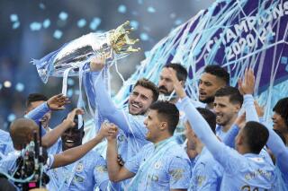 Manchester City players celebrate winning the English Premier League title after the soccer match between Manchester City and Everton at the Etihad stadium in Manchester, Sunday, May 23, 2021.(AP Photo/Dave Thompson, Pool)