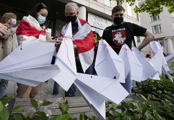 Protesters attach paper planes during a demonstration of Belarusians living in Poland and Poles supporting them in front of European Commission office in Warsaw demanding freedom for Belarus opposition activist Raman Protasevich in Warsaw, Poland, Monday, May 24, 2021. Western outrage grew and the European Union threatened more sanctions Monday against Belarus over its forced diversion of a passenger jet to the capital of Minsk in order to arrest opposition journalist Raman Protasevich in a dramatic gambit that some said amounted to state terrorism or piracy. (AP Photo/Czarek Sokolowski)