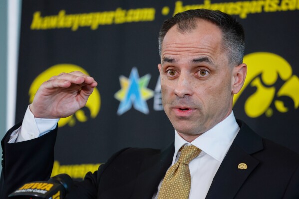 FILE -Iowa's new men's basketball head coach Ben McCollum speaks during a news conference at Carver-Hawkeye Arena in Iowa City, Iowa, Tuesday, March 25, 2025. (Jim Slosiarek/The Gazette via AP, File)