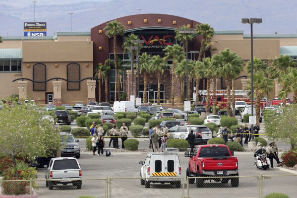 Las Vegas Metro Police officers are shown in front of a Las Vegas Athletic Club after a shooting Friday, May 16, 2025, in Las Vegas. (Steve Marcus/Las Vegas Sun via AP)