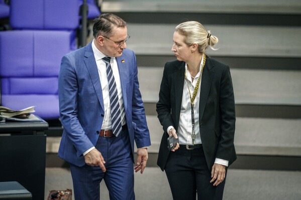 Tino Chrupalla, left, Alternative For Germany (AfD) federal chairman and AfD parliamentary group leader, and Alice Weidel, right, AfD parliamentary group leader, take part in a meeting of the German federal parliament, Bundestag, at the Reichstag building in Berlin, Germany, Thursday, Jan. 18, 2024. Germany’s governing parties have assailed a resurgent far-right opposition party over a report that extremists recently met to discuss the deportation of millions of immigrants, including German citizens, which has led to a string of protests in recent days. (Kay Nietfeld/dpa via AP)