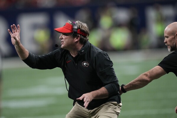 Georgia head coach Kirby Smart talks to players during the first half of the Southeastern Conference championship NCAA college football game against Alabama in Atlanta, Saturday, Dec. 2, 2023. (AP Photo/John Bazemore)