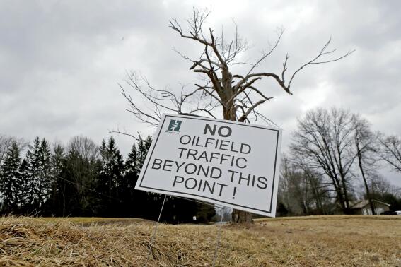 In this March 20, 2014 photo, a sign near a gas well drilling site is visible near a road in Pulaski, Pa. The gas drilling company Hilcorp that is working the well has asked state officials to invoke a 1961 law in the rural area and allow Utica Shale well bores under the property of four landowners who have not signed leases. (AP Photo/Keith Srakocic)