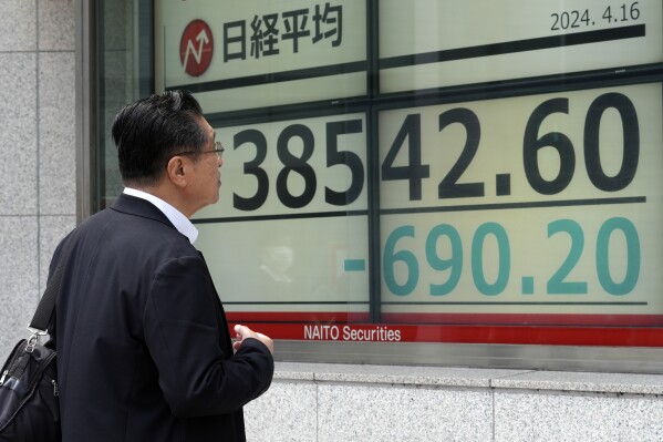 A person looks at an electronic stock board showing Japan's Nikkei 225 index at a securities firm Tuesday, April 16, 2024, in Tokyo. (AP Photo/Eugene Hoshiko)
