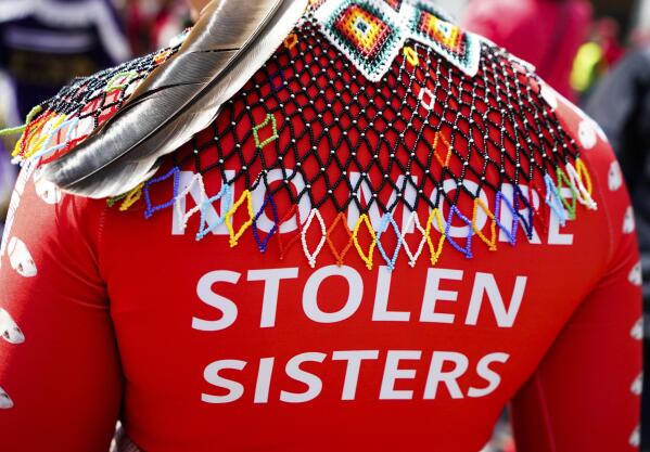 A marcher wears a shirt reading "No more stolen sisters" during the third annual march and gathering for Missing & Murdered Indigenous Women, People & Families, hosted by the grassroots organization MMIWP Families, Saturday, May 6, 2023, in Seattle. (AP Photo/Lindsey Wasson)