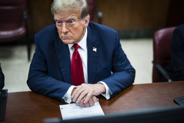 Former President Donald Trump sits inside a Manhattan criminal court with his legal team on the first day of jury selection, in New York, April 15, 2024. (Photo by Jabin Botsford/Washington Post via AP, Pool)