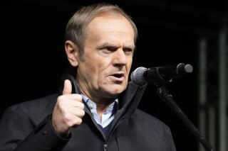 Donald Tusk, the leader of Poland's largest opposition party, Civic Platform, speaks to people joining a demonstration after the Polish parliament approved a bill that is widely viewed as an attack on media freedom, in Warsaw, Poland, Sunday Dec. 19, 2021. Poles flocked to city centers across the country to defend a U.S.-owned television network that is being targeted by the right-wing government. The protests Sunday evening are seeking to protect media freedom in a European Union nation where democratic norms are eroding. (AP Photo/Czarek Sokolowski)