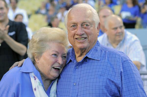 FILE - Tommy Lasorda and his wife Jo hug as they watch a video tribute to Tommy prior to the Los Angeles Dodgers' baseball game against the Colorado Rockies in Los Angeles, in this Saturday, Sept. 28, 2013, file photo. Jo Lasorda has died. She was 91. She died Monday night, Sept. 20, 2021, at her home in Fullerton, the team said Tuesday. No cause of death was given. (AP Photo/Mark J. Terrill)