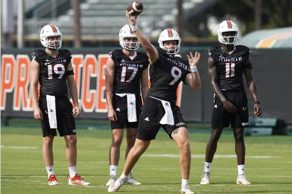 Miami quarterback Tyler Van Dyke (9) throws a pass at the team's NCAA college football facility, Friday, Aug. 5, 2022, in Coral Gables, Fla. (AP Photo/Marta Lavandier)
