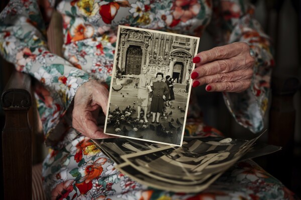 Bambi holding a photo of her with her mother. (AP Photo/Thomas Padilla)