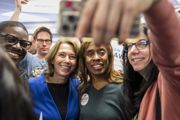 Wisconsin Supreme Court candidate Susan Crawford has her photo taken with supporters Saturday, March 29, 2025 at a campaign stop at a field office for the Democratic Party of Wisconsin, in Milwaukee. (AP Photo/Andy Manis)