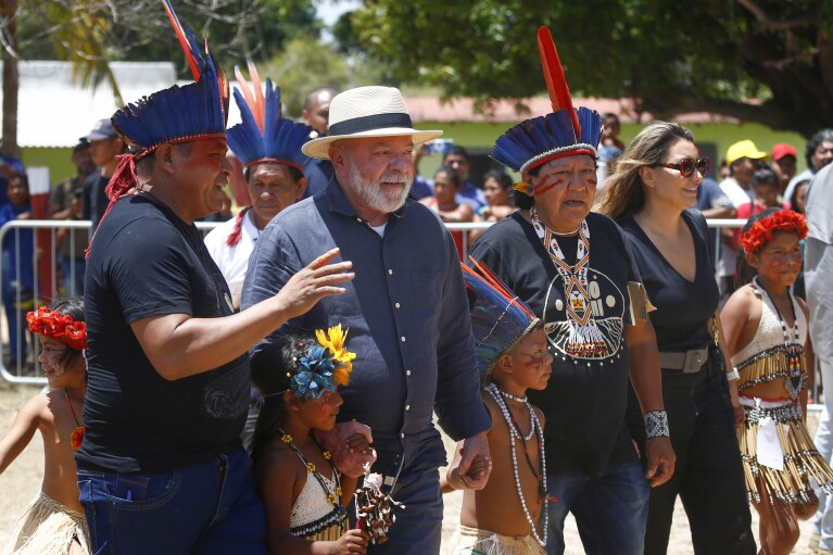 FILE - Brazil's President Luiz Inacio Lula da Silva, second left, and first lady Rosangela Silva, second from right, are received by an Indigenous party including Davi Kopenawa, a Yanomami leader and shaman, third from right, at the Caracarana Lake Regional Center in Normandia, on the Raposa Serra do Sol Indigenous reserve in Roraima state, Brazil, March 13, 2023. Rio de Janeiro's Salgueiro samba school paid tribute to the the Yanomami, Brazil鈥檚 largest Indigenous group, on Sunday, Feb. 11, 2024 in the Carnival parade at the Sambadrome. (APPhoto/Edmar Barros, File)