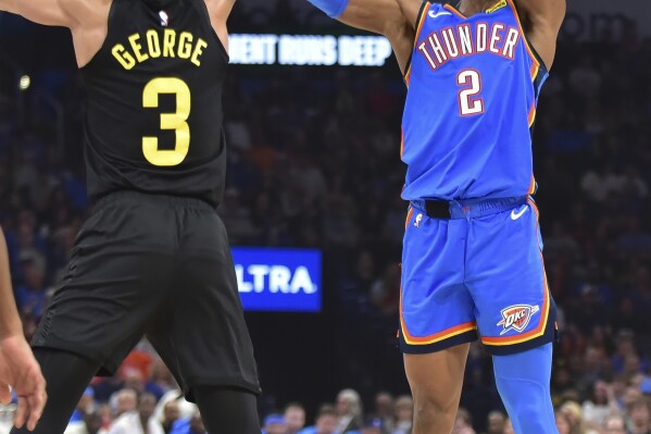 Oklahoma City Thunder guard Shai Gilgeous-Alexander (2) shoots against Utah Jazz guard Keyonte George (3) during the first half of an NBA basketball game Wednesday, March 20, 2024, in Oklahoma City. (AP Photo/Kyle Phillips)