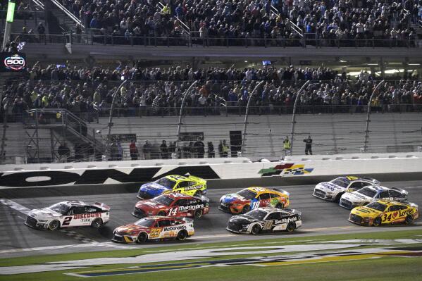FILE - Austin Cindric (2) takes the checkered flag in front of Bubba Wallace (23) to win the NASCAR Daytona 500 auto race at Daytona International Speedway, Sunday, Feb. 20, 2022, in Daytona Beach, Fla. As Kevin Harvick prepares to depart, the stage is open to be seized by Noah Gragson, watermelon farmer Ross Chastain and Daniel Suarez, the only Mexican-born winner in NASCAR history. There’s also Cindric, a Team Penske fixture who won last year’s Daytona 500 as a rookie on Roger Penske’s 85th birthday, or Bubba Wallace, the only Black driver competing at NASCAR’s top level. (AP Photo/Phelan M. Ebenhack, File)