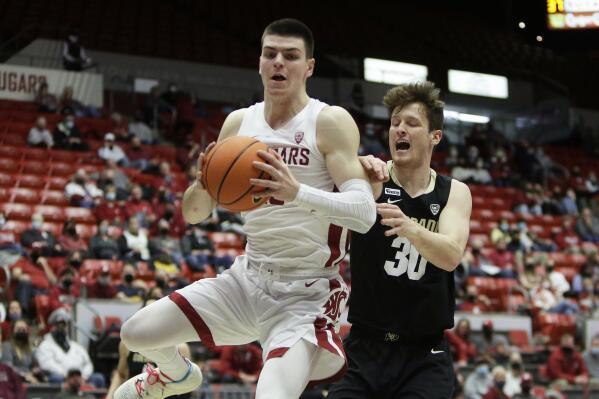 Washington State forward Andrej Jakimovski, left, grabs a rebound in front of Colorado forward Will Loughlin during the second half of an NCAA college basketball game, Sunday, Jan. 30, 2022, in Pullman, Wash. Washington State won 70-43. (AP Photo/Young Kwak)