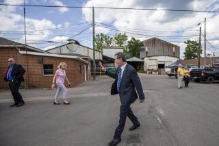 North Carolina Governor Roy Cooper waves goodbye as he leaves the Pine Hall Brick plant after visiting the COVID-19 vaccine clinic at the brick plant in Madison, N.C., on Thursday, May 27, 2021. (Woody Marshall/News & Record via AP)