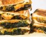 This image released by Milk Street shows a recipe for kale and cheddar melts. (Milk Street via AP)
