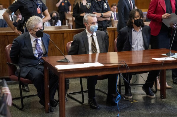 FILE - From left, Glenn Horowitz, Craig Inciardi and Edward Kosinski appear in criminal court after being indicted for conspiracy involving handwritten notes from the famous Eagles album "Hotel California," July 12, 2022, in New York. On Wednesday, Feb. 21, 2024, an unusual criminal trial is set to open over the handwritten lyrics. (AP Photo/John Minchillo, File)