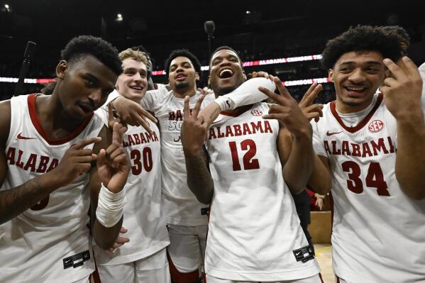 Alabama players celebrate on the court after an NCAA college basketball game against Texas A&M in the finals of the Southeastern Conference Tournament, Sunday, March 12, 2023, in Nashville, Tenn. (AP Photo/John Amis)