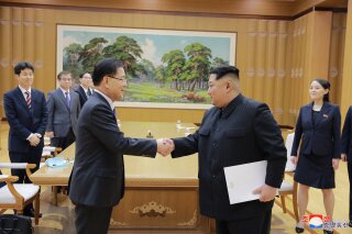 
              In this Monday, March 5, 2018 photo, provided by the North Korean government on March 6, North Korean leader Kim Jong Un, front right, shakes hands with South Korean National Security Director Chung Eui-yong after Chung gave Kim the letter from South Korean President Moon Jae-in, in Pyongyang, North Korea. Independent journalists were not given access to cover the event depicted in this image distributed by the North Korean government. The content of this image is as provided and cannot be independently verified. Korean language watermark on image as provided by source reads: "KCNA" which is the abbreviation for Korean Central News Agency. (Korean Central News Agency/Korea News Service via AP)
            