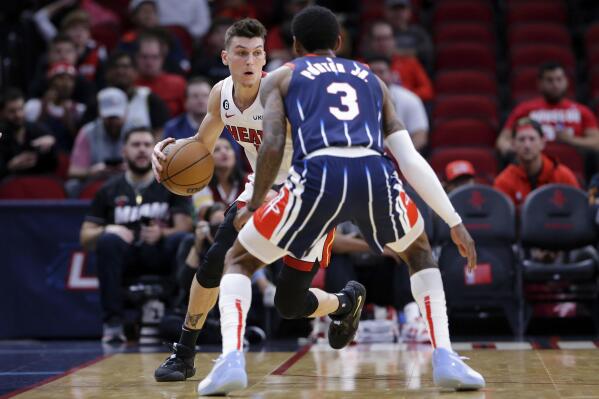 Miami Heat guard Tyler Herro, left, looks to drive around Houston Rockets guard Kevin Porter Jr. (3) during the first half of an NBA basketball game Thursday, Dec. 15, 2022, in Houston. (AP Photo/Michael Wyke)