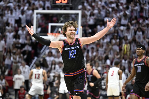 Boise State guard Max Rice (12) celebrates after hitting a 3-point shot against San Diego State during the second half of an NCAA college basketball game Friday, March 8, 2024, in San Diego. (AP Photo/Denis Poroy)