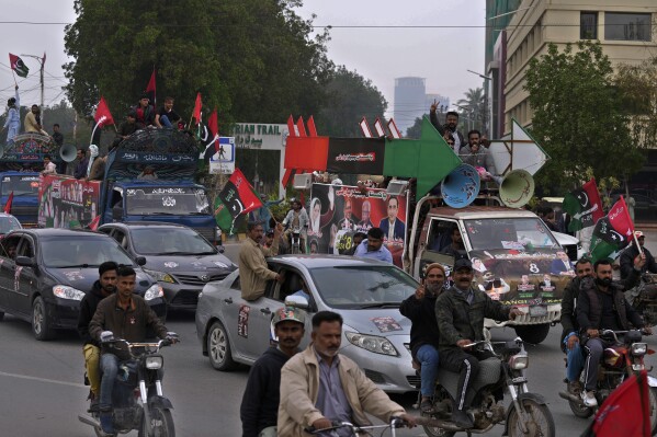 Supporters of Pakistan People's Party travel on vehicles and bikes as they wave party flags and flashing victory signs during an election campaign rally, in Karachi, Pakistan, Monday, Feb. 5, 2024. The elections are the twelfth in the country's 76-year history, which has been marred by economic crises, military takeovers and martial law, militancy, political upheavals and wars with India. (AP Photo/Fareed Khan)