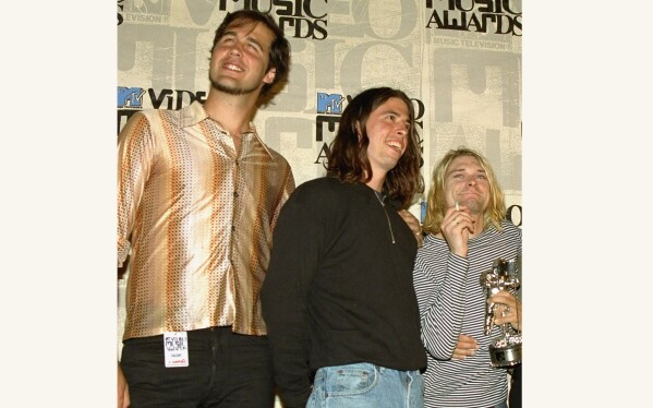 FILE - Nirvana band members Krist Novoselic, from left, Dave Grohl and Kurt Cobain pose after receiving the award for best alternative video for "In Bloom" at the 10th annual MTV Video Music Awards on Sept. 2, 1993, in Universal City, Calif. Apple Music announced on Wednesday, May 22, 2024, their 10 greatest albums of all time and Nirvana's 1991 “Nevermind” came in ninth on the list. (AP Photo/Mark J. Terrill, File)