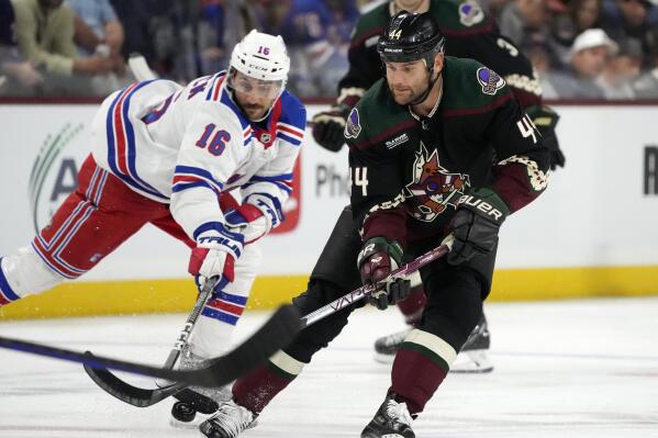 Arizona Coyotes right wing Zack Kassian (44) tries to keep the puck away from New York Rangers center Vincent Trocheck (16) during the first period of an NHL hockey game at Mullett Arena in Tempe, Ariz., Sunday, Oct. 30, 2022. (AP Photo/Ross D. Franklin)