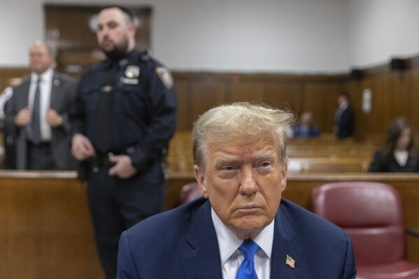 Former President Donald Trump waits for proceedings to begin during jury selection in Manhattan Criminal Court, Thursday, April 18, 2024 in New York.  Jeenah Moon/Bloomberg