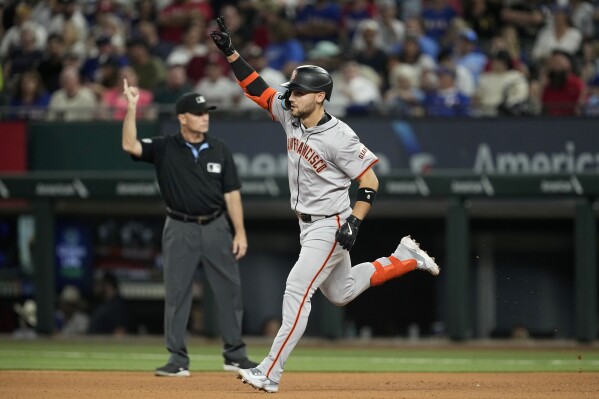 San Francisco Giants' Michael Conforto celebrates his two-run home run against the Texas Rangers in the seventh inning of a baseball game, Friday, June 7, 2024, in Arlington, Texas. Matt Chapman also scored on the shot. (AP Photo/Tony Gutierrez)