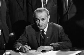 President Johnson signed into law the new Civil Rights Bill, April 11, 1968, in Washington. The bill signing ceremony took place in the East Room in the White House. (AP Photo)