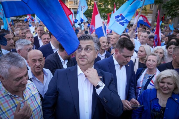 Prime Minister incumbent Andrej Plenkovic, centre, attends his party's rally in Zagreb, Croatia, Sunday, April 14, 2024. Croatia this week holds a parliamentary election following a campaign that was marked by heated exchanges between the country's two top officials, creating a political crisis in the Balkan country, a European Union and NATO member state. (AP Photo/Darko Bandic)