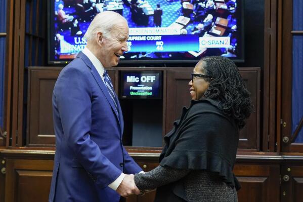President Joe Biden holds hands with Supreme Court nominee Judge Ketanji Brown Jackson as they watch the Senate vote on her confirmation from the Roosevelt Room of the White House in Washington, Thursday, April 7, 2022. (AP Photo/Susan Walsh)