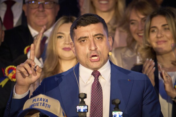 Presidential candidate George Simion speaks to media after polls closed for the second round of the country's presidential election redo in Bucharest, Romania, Sunday, May 18, 2025. (AP Photo/Vadim Ghirda)