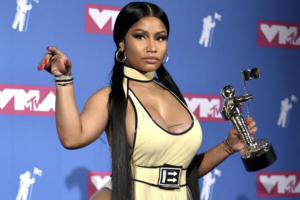 FILE - Nicki Minaj poses in the press room with her award for best hip-hop video for "Chun-Li" at the MTV Video Music Awards in New York on Aug. 20, 2018. Minaj will receive the Video Vanguard Award at the MTV Awards later this month. Minaj, who has won five MTV trophies for such hits as “Anaconda,” “Chun-Li” and “Hot Girl Summer,” will get the award and perform at the ceremony on Aug. 28 at the Prudential Center in Newark, N.J. (Photo by Evan Agostini/Invision/AP, File)