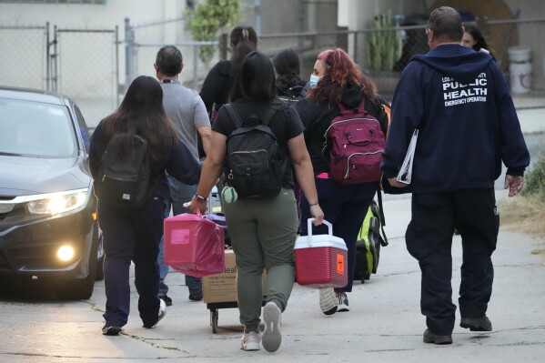 Los Angeles County Public Health Emergency Operations officials leave St. Anthony's Croatian Catholic Church after evaluating newly arrived migrants being housed in the Chinatown area of Los Angeles on Wednesday, June 14, 2023. A group of migrants, including some children, who arrived by bus from Texas, were dropped off at Union Station Wednesday and were being cared for at the church. Texas Gov. Greg Abbott said the migrants were sent to Los Angeles because California had declared itself a 