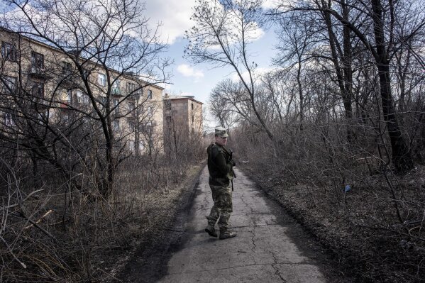
              A Ukrainian solder patrols in the village of Zolote 4, eastern Ukraine, Friday, March 29, 2019.  Five years after a deadly separatist conflict in eastern Ukraine, a generation of first-time voters in the rebel-held Donetsk and Luhansk areas has been cut off from Sunday's Ukrainian presidential election. (AP Photo/Evgeniy Maloletka)
            
